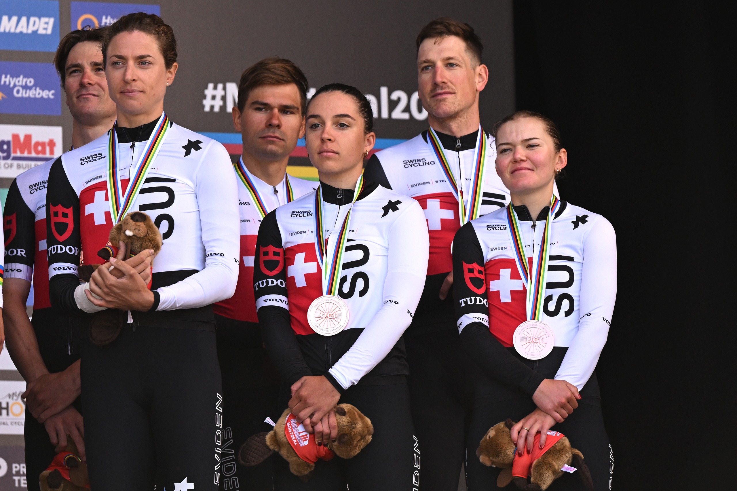 The Swiss team stand on the podium after winning the bronze medal in the mixed relay TTT in the 2026 UCI Road World Championships