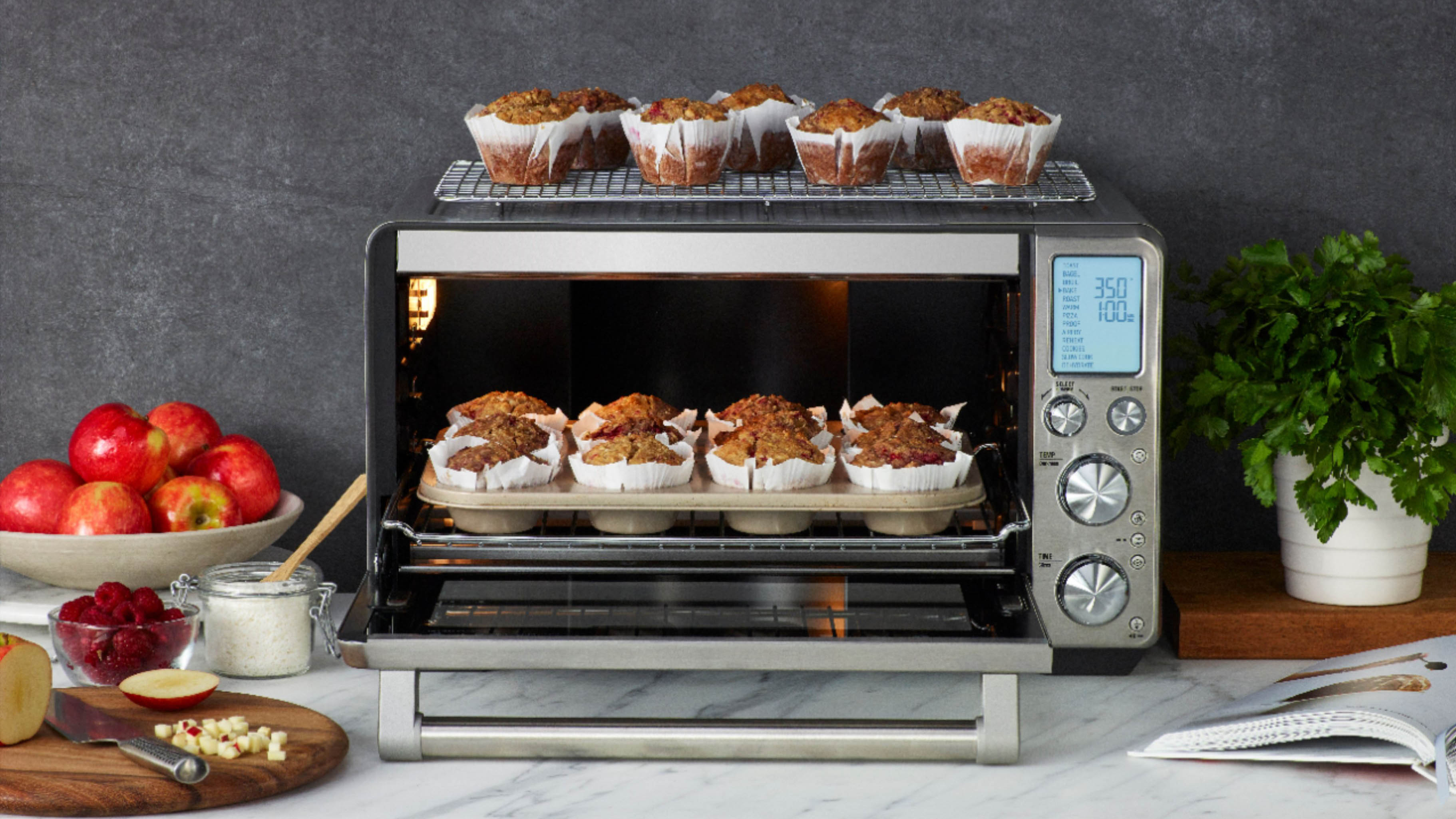 Breville Smart Oven Air Fryer Pro sitting on a counter with fresh muffins