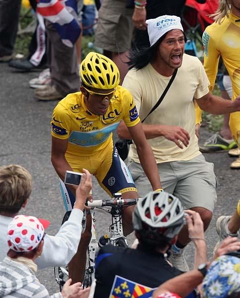 Race leader Alberto Contador (Astana) rides stage 17, cheered by fans.