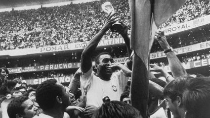 Pelé holds up the Jules Rimet Trophy