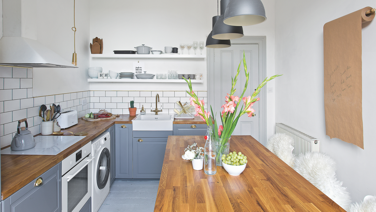 mall kitchen with grey units, white walls and wall tiles, wooden worktop and kitchen table. Pub Orig Rachelle and Ben Garnham&#039;s three bedroom two floor tenement flat in a Georgian townhouse in Edinburgh.