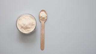 Jar of collagen powder with spoon