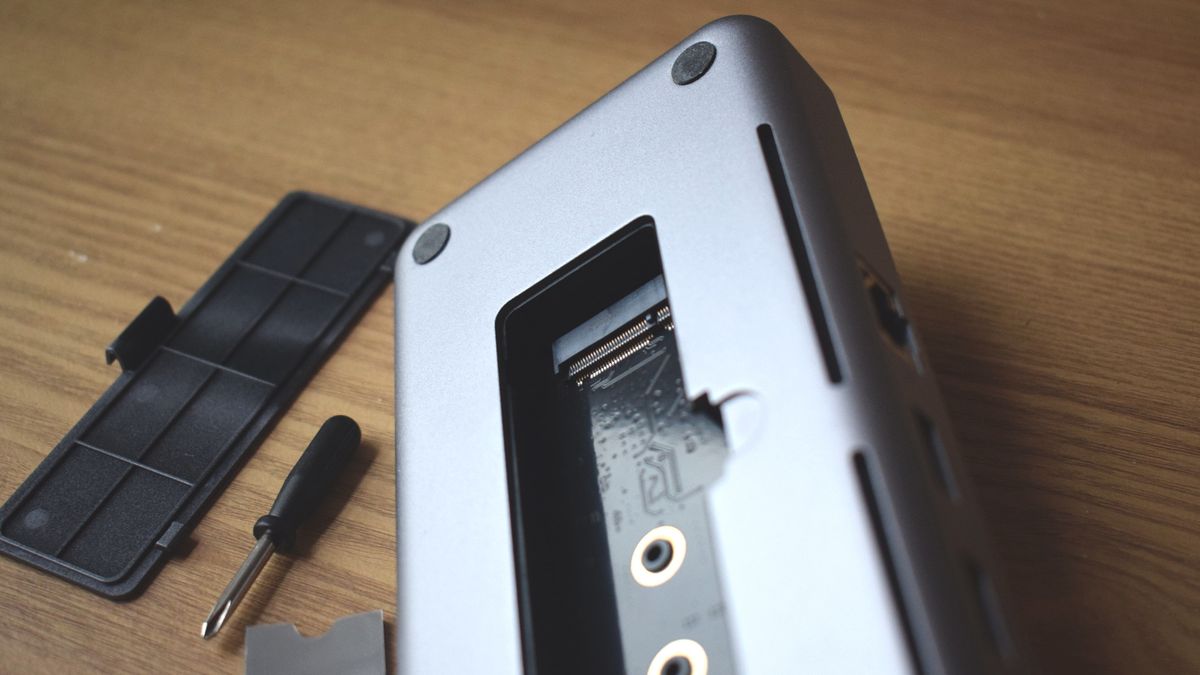 An image of the base of the Satechi Dual Dock Stand, with its SSD enclosure opened to reveal a free NVMe SSD slot.