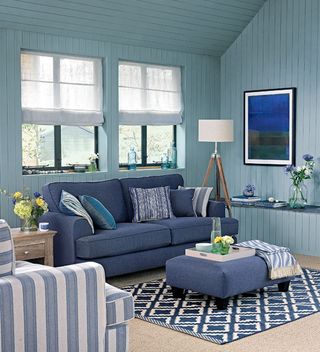 living room with blue sofa and rug