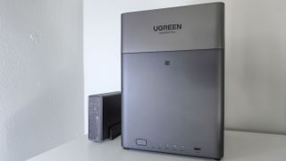 The Ugreen US3000 mini UPS next to a Ugreen NAS on a shelf