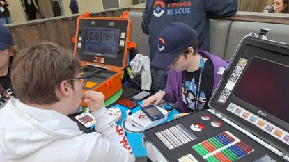 Photo of the Pokemon Rescue team helping someone with a Pokemon transfer at the Pokemon Europe International Championships 2026.