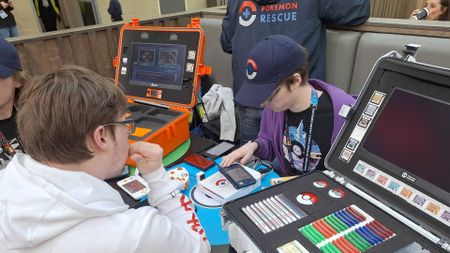 Photo of the Pokemon Rescue team helping someone with a Pokemon transfer at the Pokemon Europe International Championships 2026.