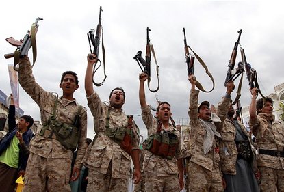 Houthi rebels brandish their weapons after a gathering. 