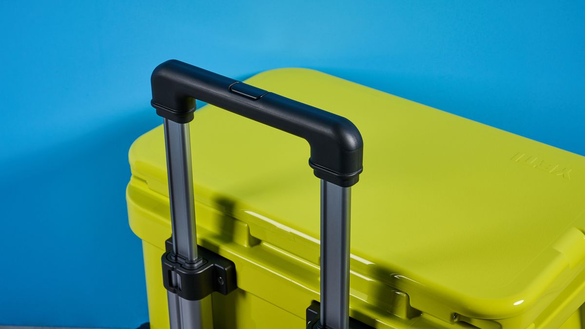 the yeti roader cooler in neon yellow with wheels, soft close hinges, a retractable handle, and 32 quart capacity