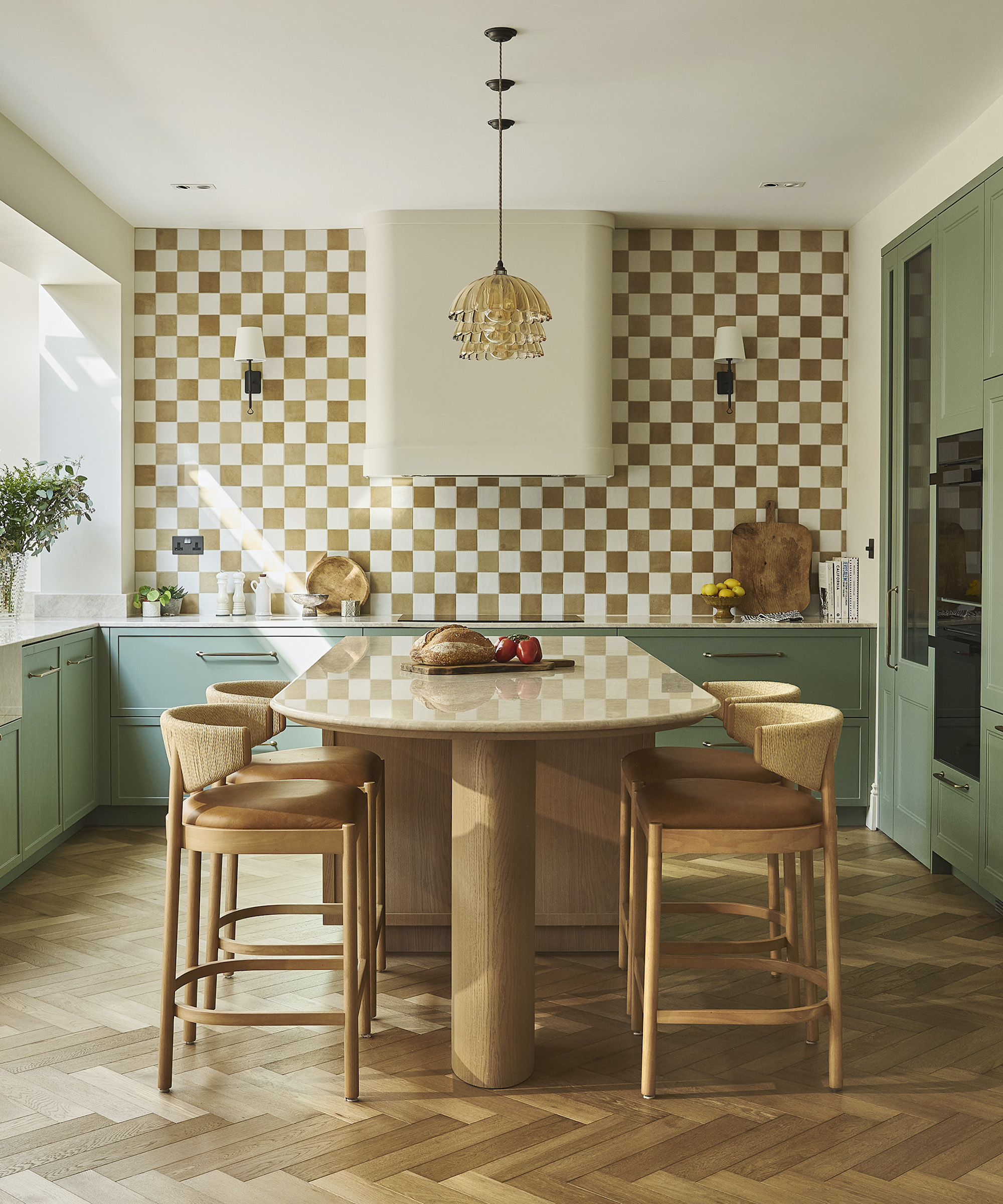 green kitchen with wood island and chequered backsplash