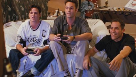 Vince Vaughn and other actors from Swingers sitting on a couch with video game controllers in their hands 