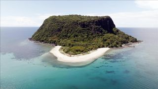 Phillip Schofield sitting on a deserted beach for Cast Away