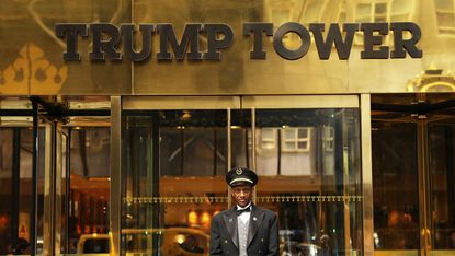 A doorman stands in front of Trump Tower on New York's Fifth Avenue