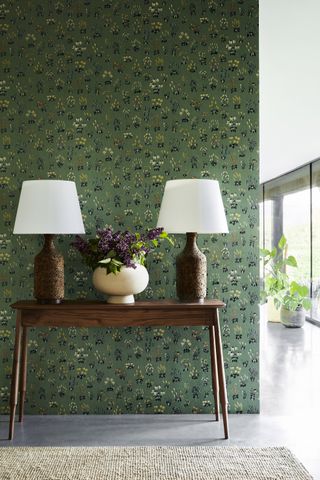 Green wallpaper with small patches of flowers