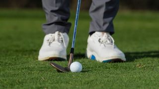 PGA pro setting up to hit a chip shot at Infinitum Golf Resort