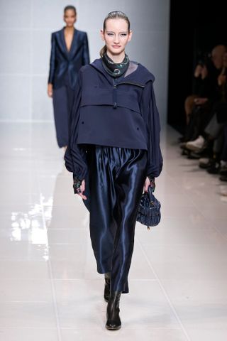 Woman in navy satin pants on Giorgio Armani runway