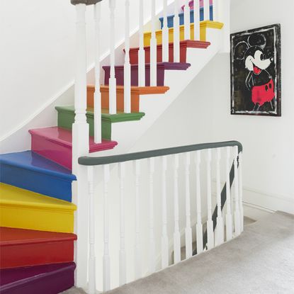 hallway with painted stairs and cartoon print