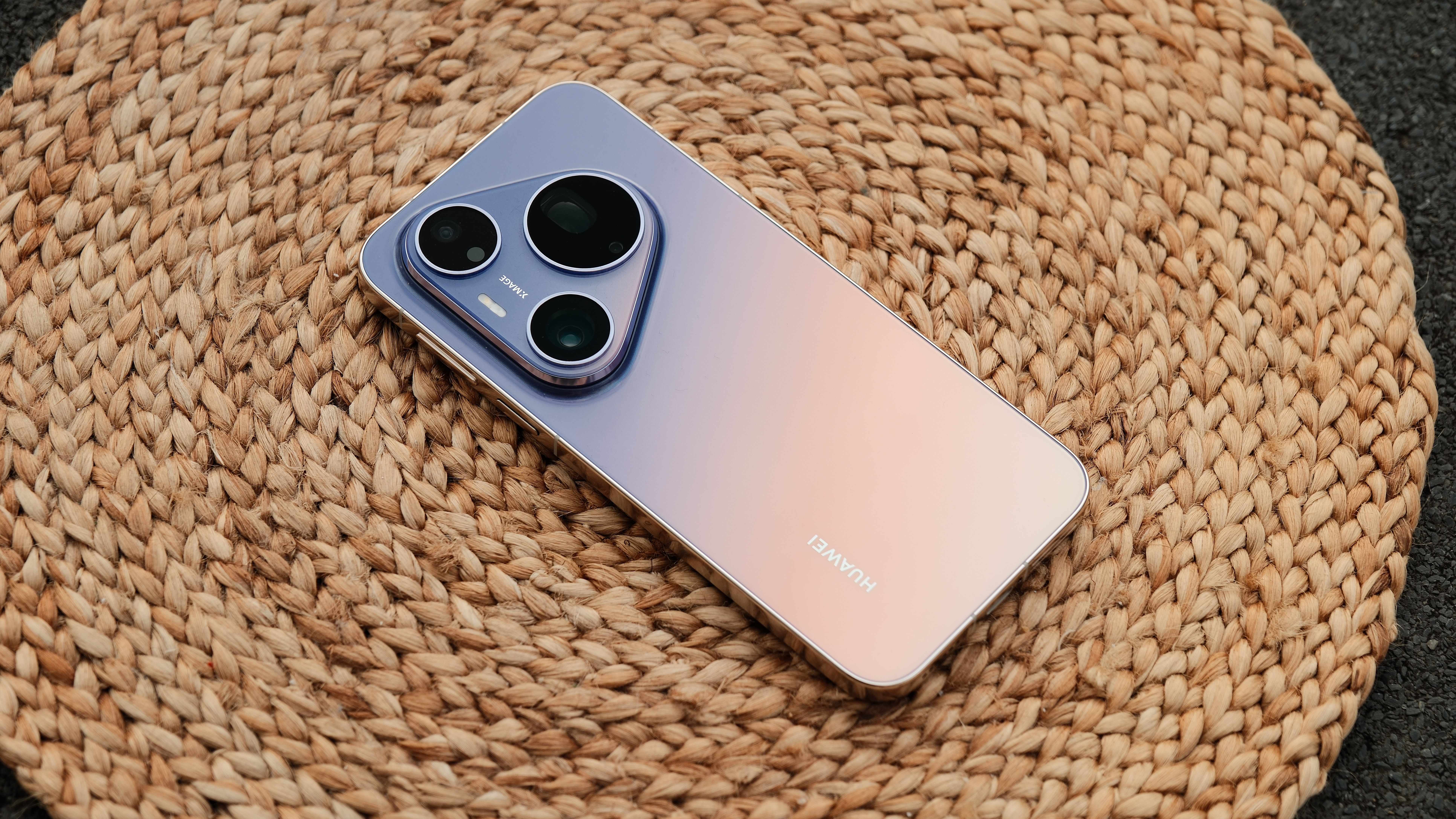 Huawei Pura90s Pro Max smartphone on a brown mat