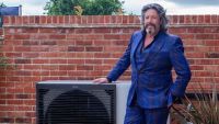 Laurence Llewelyn-Bowen stood next to a heat pump