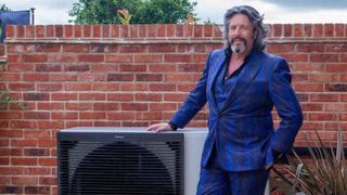 Laurence Llewelyn-Bowen stood next to a heat pump