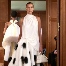 Irina Shayk walks the Jacquemus runway in a white dress 