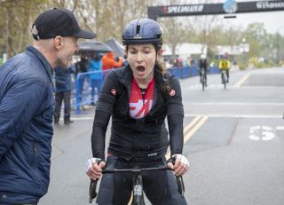 Lauren De Crescenzo reacts to winning inaugural The Growler road race at the finish, greeted by race founder Levi Leipheimer