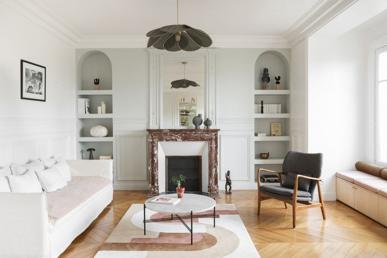 A living room with a fireplace in the middle