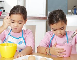 identical twins beating some eggs