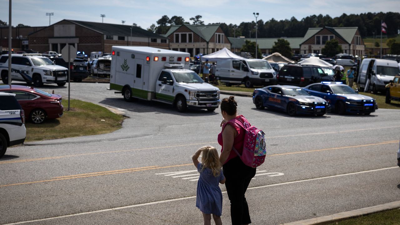 Girl and mother stand outside Georgia&#039;s Apalachee High School after school shooting