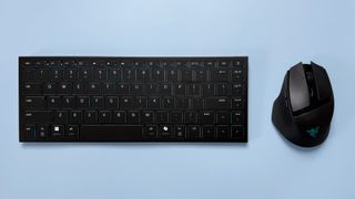 A Razer Basilisk Mobile gaming mouse and Razer Joro portable gaming keyboard on a blue background.