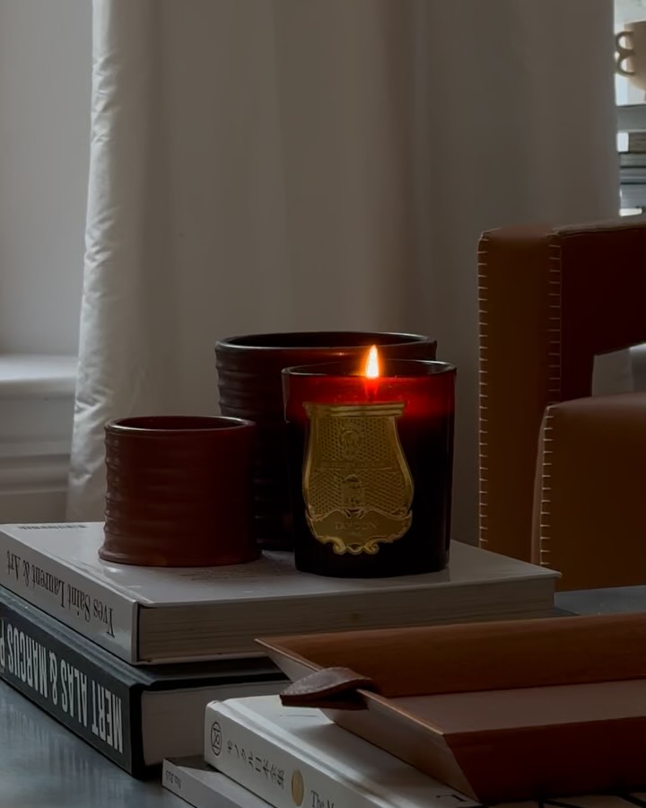 Trudon and Loewe candles on top of coffee table books