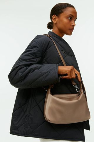 arket sale - woman wearing brown medium sized crossbody bag