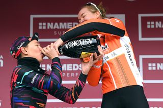 Katarzyna Niewiadoma and Anna van der Breggen share a drink on the Strade Bianche podium