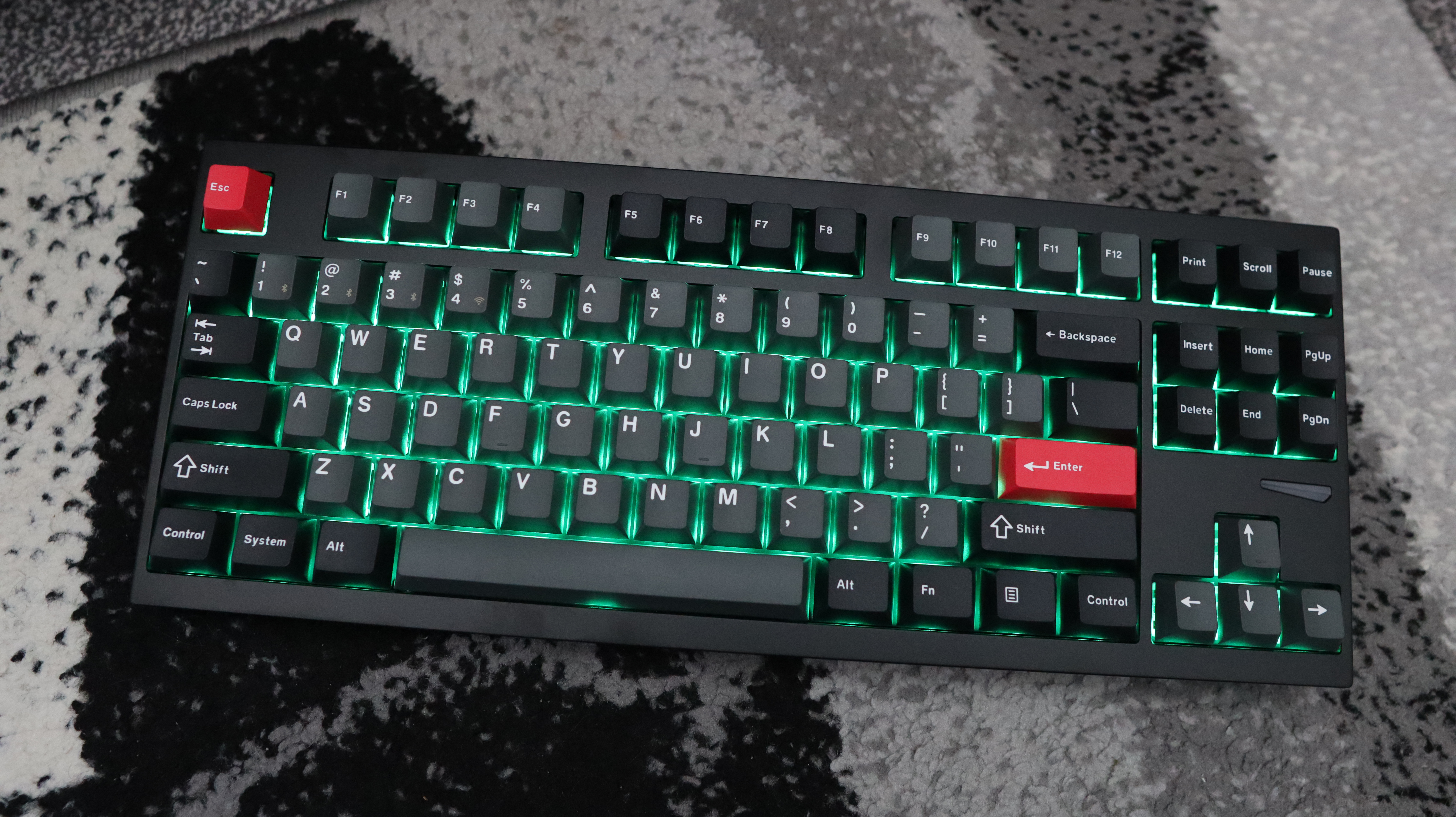 Lemokey L4 gaming keyboard on a carpet with lighting enabled.