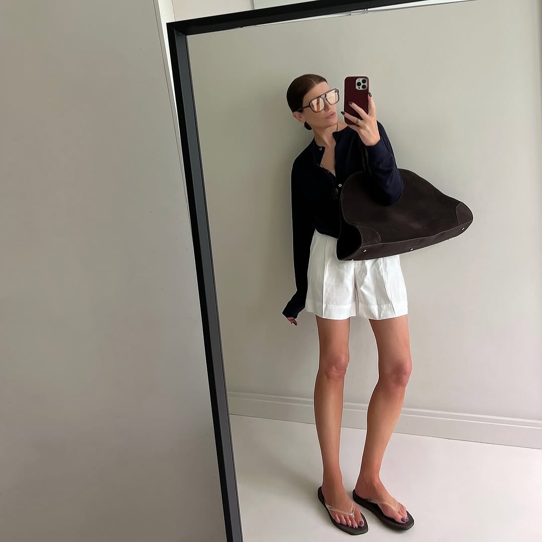 Woman wearing fall brown suede bag trend.