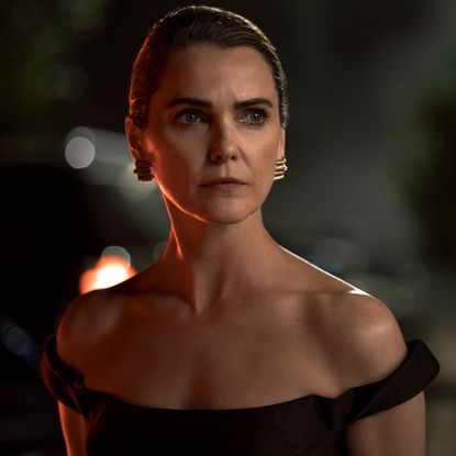 keri russell as kate wyler wearing an off the shoulder dress looking in the distance in a still from the diplomat season 4