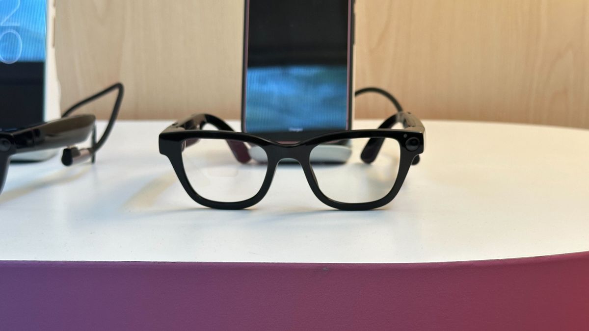 Android XR prototype glasses in front of a Pixel smartphone