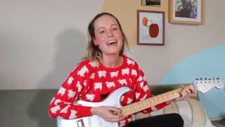 Brie Larson playing guitar