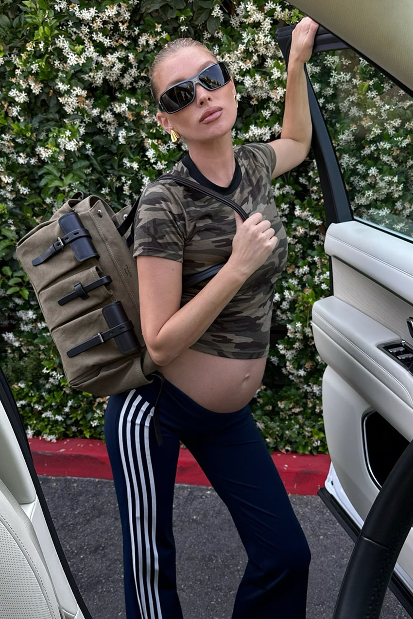 A woman wearing a camo shirt and black pants.