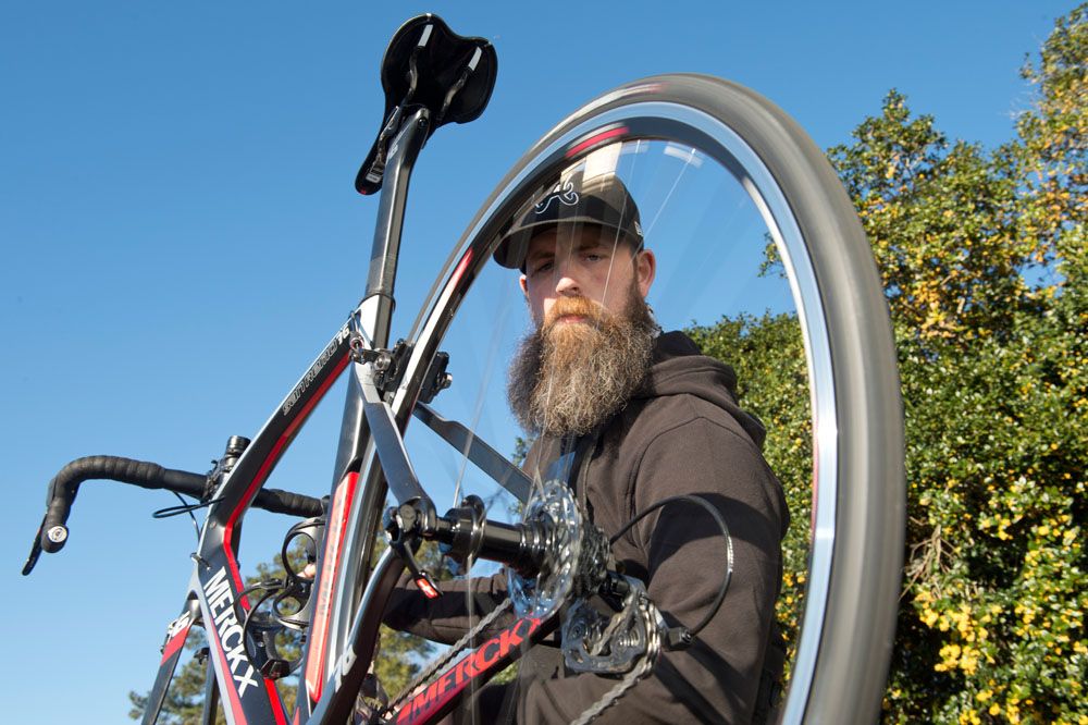 Zack Foley tunes up one of the new Merckx San Remo bikes before a ride.