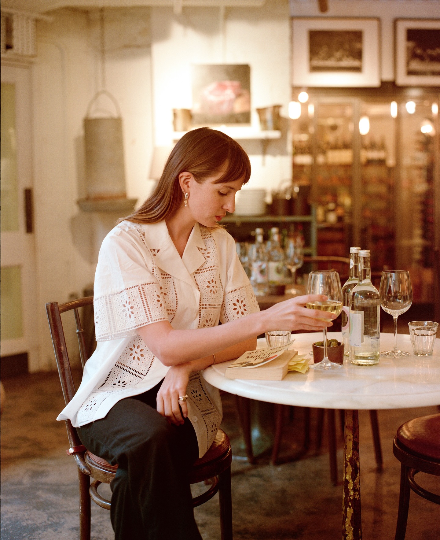 Lizzy Hadfield wearing a broderie anglaise shirt and black trousers.