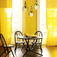 primary yellow sheer curtains in dining room