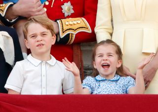Prince George of Cambridge and Princess Charlotte of Cambridge watch a flypast from the balcony of Buckingham Palace during Trooping The Colour