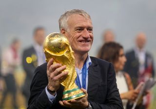 Didier Deschamps holds the World Cup trophy in 2018 after France's win over Croatia.