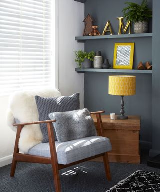 grey living room corner with chair and wall shelves