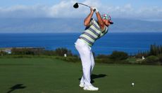 Tyrrell Hatton strikes a tee shot at The Sentry with the ocean in front of him