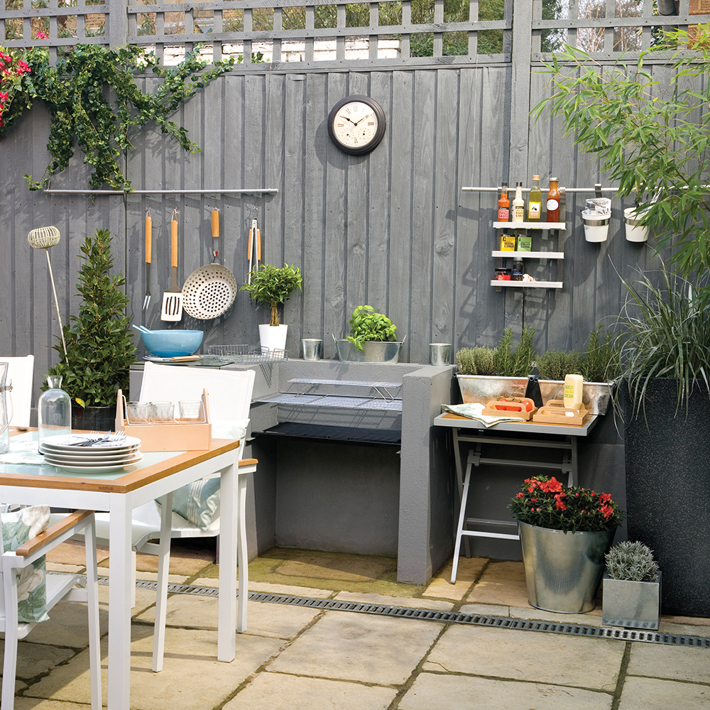 garden area with grey fence and table