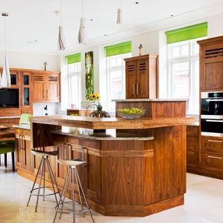 kitchen area with island units and white wall