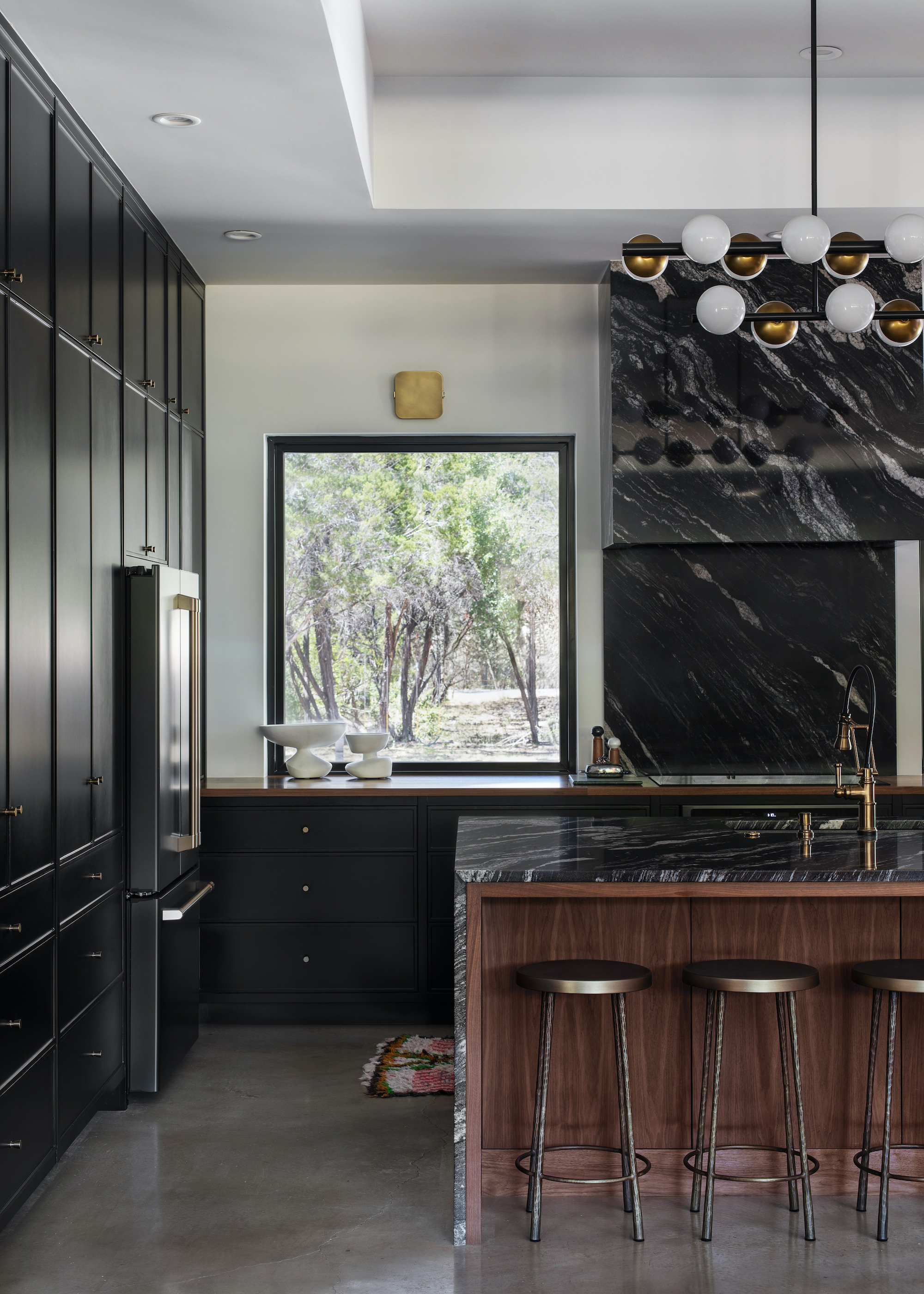 black kitchen with wood island