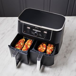 Ninja dual zone air fryer with two compartments cooking food